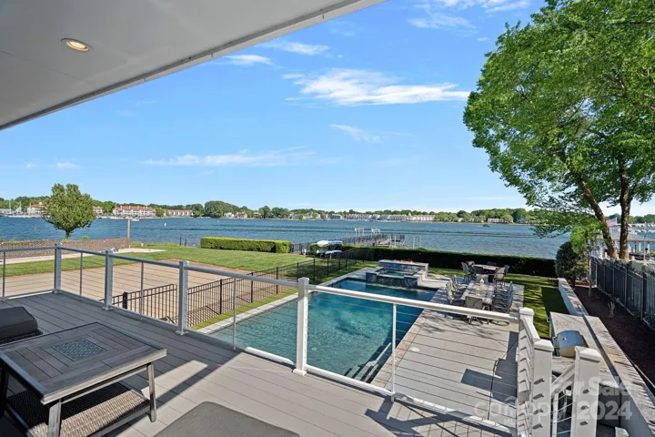 Huge lakeside pool and hottub with large decking for entertaining and enjoying time outside.