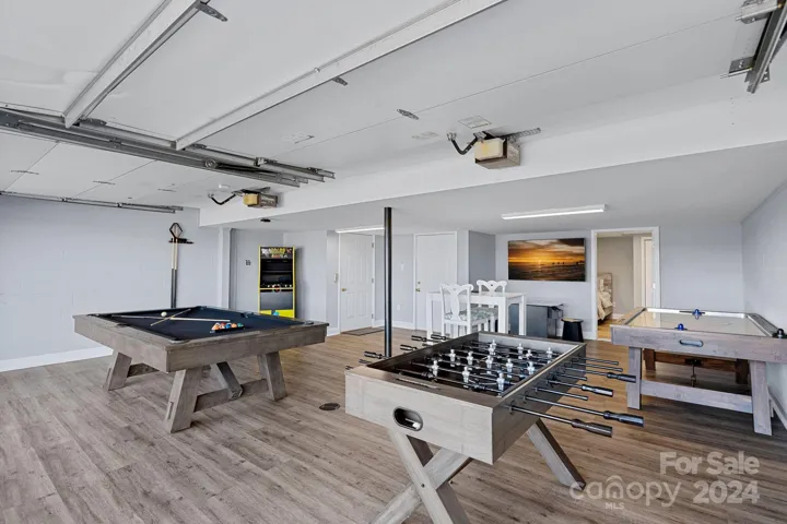 The garage has been converted into a game room with LVP flooring. Elevator entry is available from here!