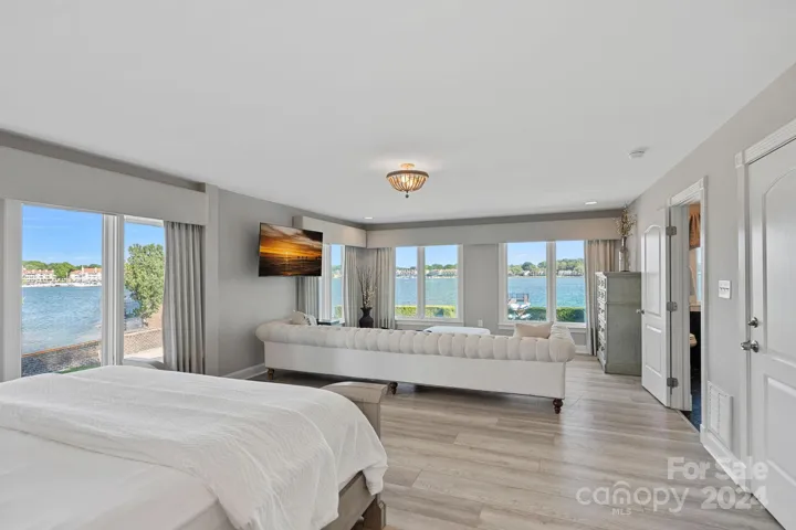 Lake views abound in this sweeping Primary Suite, complete with 2 bathrooms!