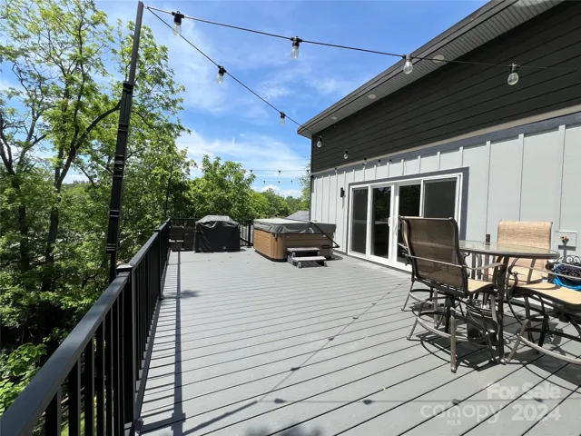Upper deck with hot tub off of main home