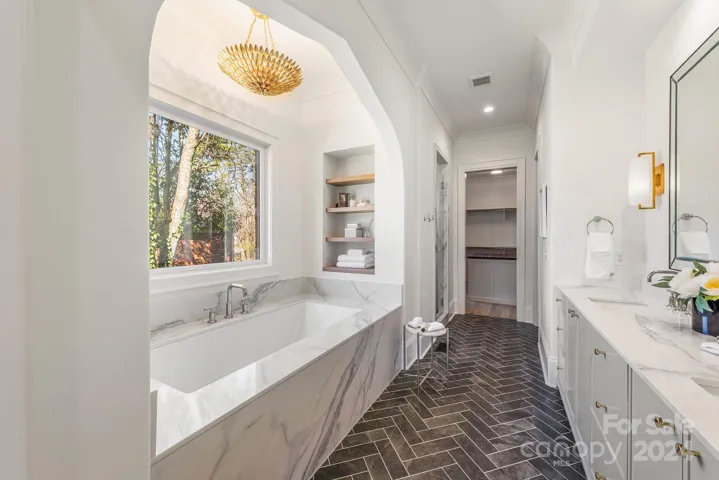 Luxurious Primary Bath features a built-in oversized soaking tub
