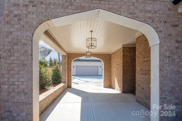 Porte Cochere with covered side entry into the home and 2 car detached garage.