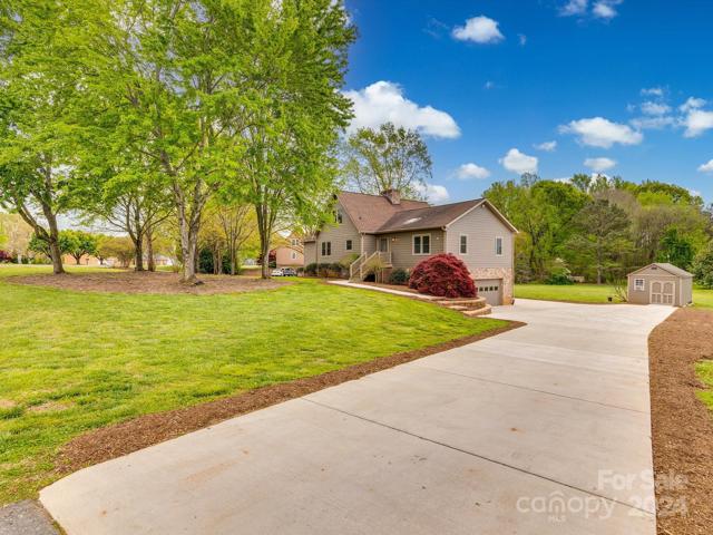 Newer concrete driveway, side-load garage.