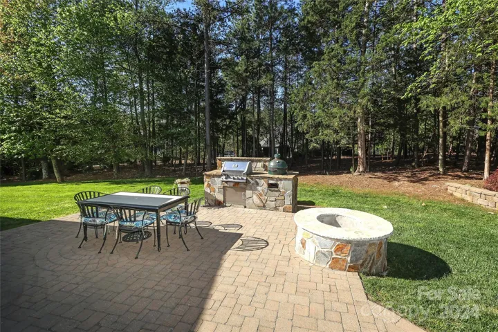Backyard-.43 acre with brick paver fire pit/grill