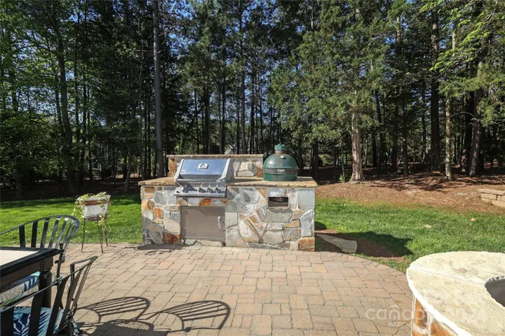 Backyard-.43 acre with brick paver fire pit/grill