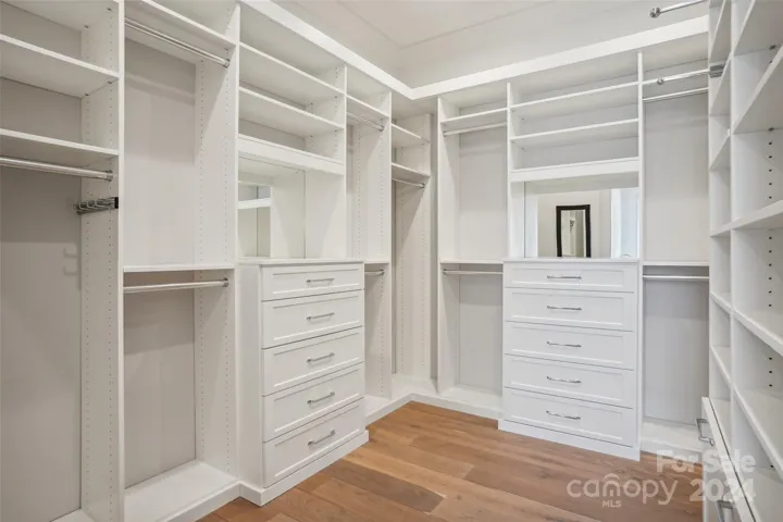 Primary closet with lots of storage