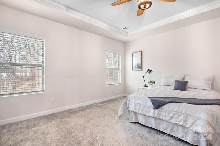 Tray ceilings equipped with a lovely fan.