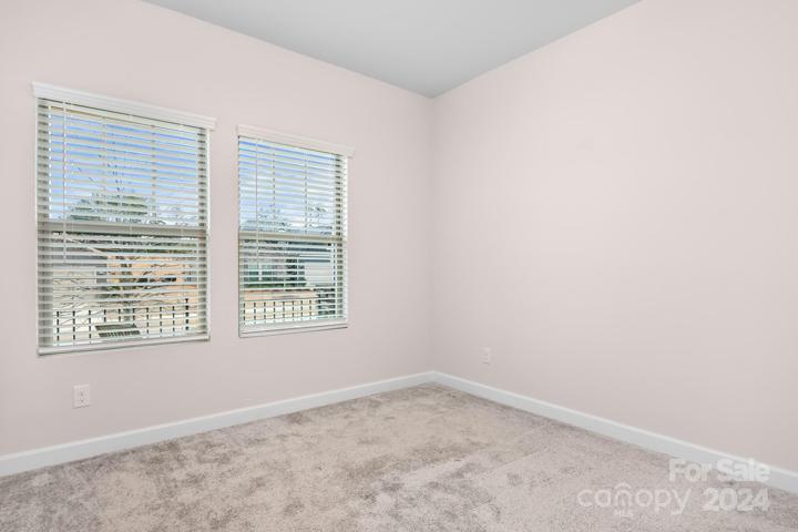 secondary bedroom on main level with a walk in closet.