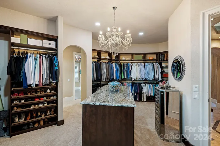 2nd laundry room is located directly beside this expansive designer closet