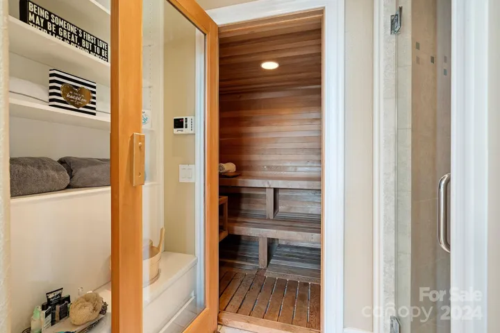 Steam shower and multi person sauna in person sauna in primary suite