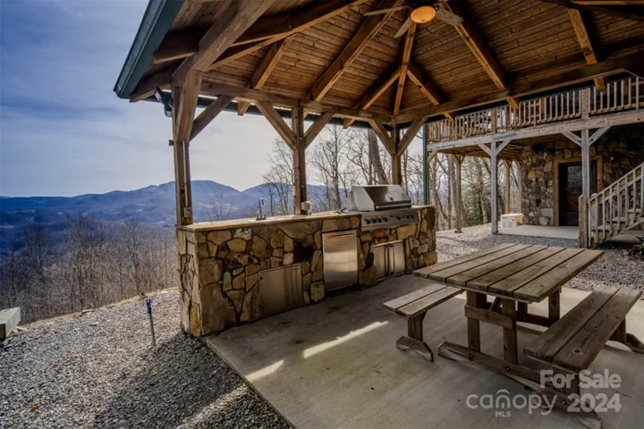 Covered outdoor kitchen w/ built in 52" Viking gas grill, sink & refrigerator