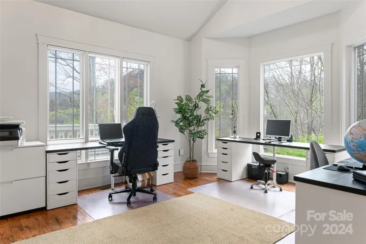 Main level office or sitting room with wall to wall windows