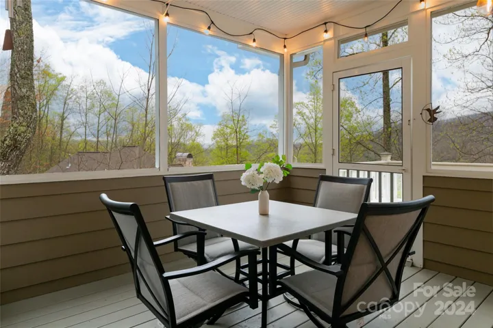 Screened in porch steps off of the kitchen for outdoor dining and relaxing