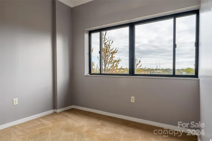 2nd bedroom across the hall, very spacious with more windows and city views