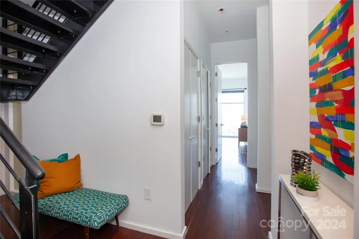 Hall to bedroom with 2 closets including laundry