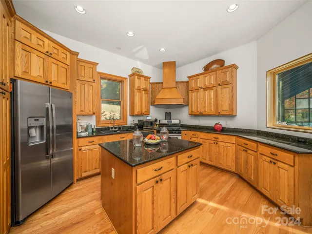 Kitchen with door to Pool area and a window for Viewing Pool while working in kitchen