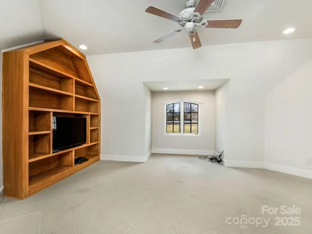 Bedroom with built in shelves and niche