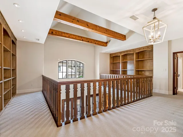 Upper floor library w built in book shelves