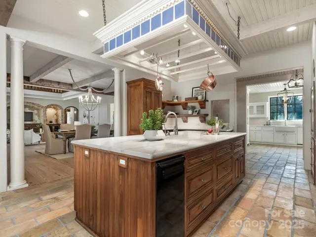 Large island w quartz counters.  GE ice maker, pull out drawers, reclaimed French ceiling tiles on the floors of kitchen, scullery, and powder rooms