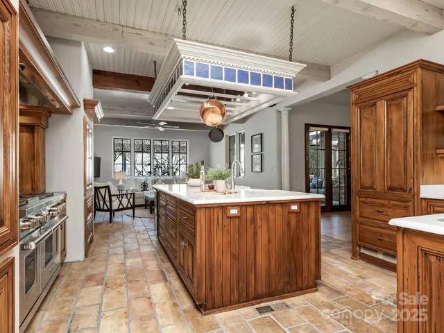 Bead board, beams, pot hanging over the island