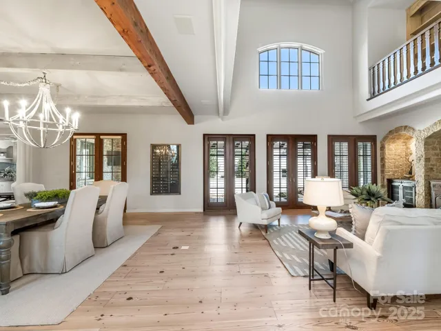 Reclaimed wide plank pine flooring on main living areas w cedar beams and mahogany doors with Rocky Mountain Hardware