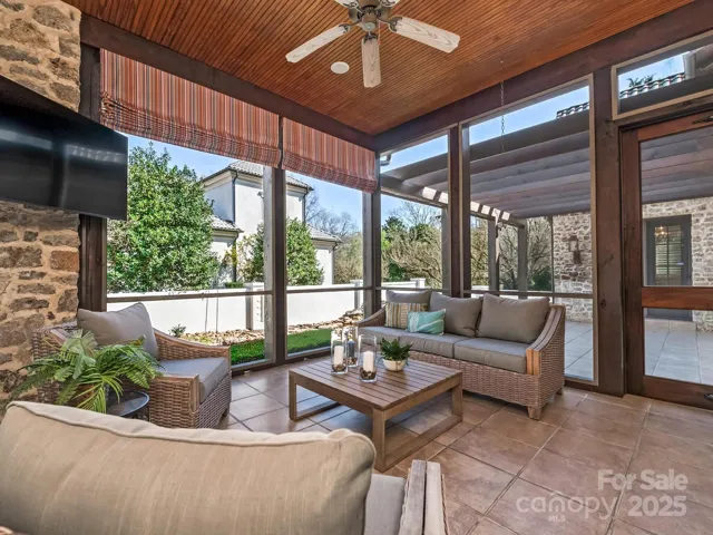 Screened in back porch with television.