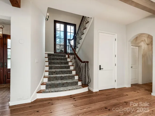 Stately stairwell with balcony on landing.