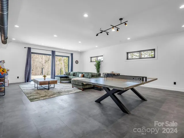 Ping Pong table, and arcade game in the finished basement entertainment room.