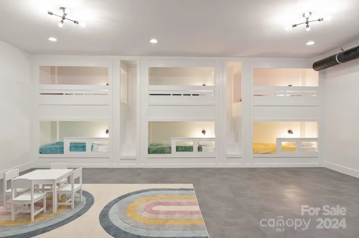 Kids' bunk room with 6 built-in bunk beds and a bounce house.