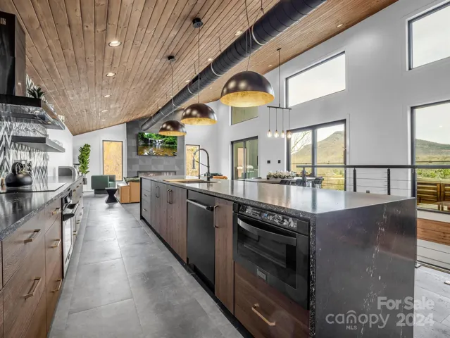 Z-Line Appliances + Oversized waterfall Granite Countertops.