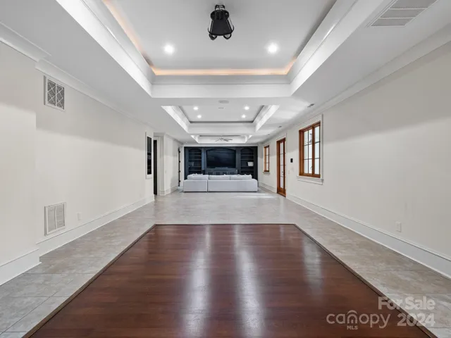 Dance floor and theater room with nice lighting also features two half baths