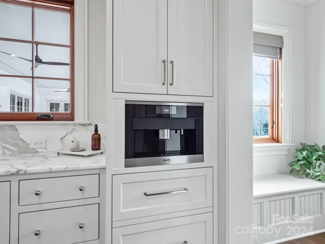 Built in coffee station with refrigerated drawers for creamers etc.