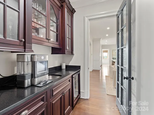 Beautiful custom butler's pantry connects the study to the kitchen space