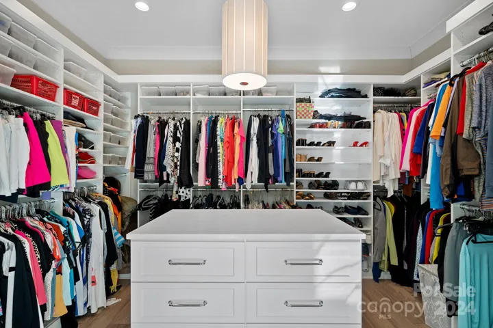 Primary Closet has 2 sided island with drawers, and 2nd W/D hookup available, and add'l 2 door closet for linen/luggage.