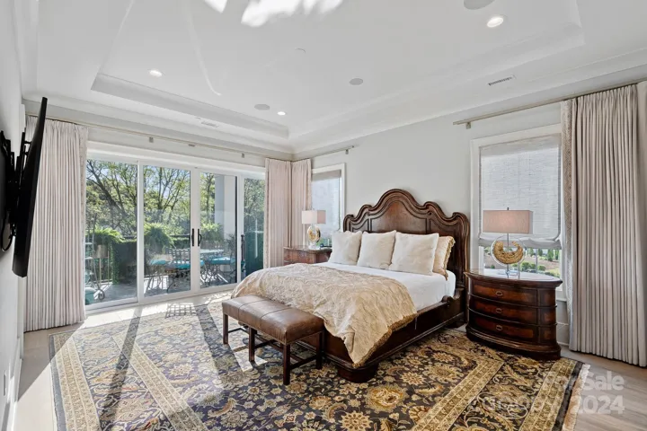 Primary suite is oversized and bright with sliders leading to balcony.  Automated SOMFY drapes provide room darkening at the touch of a button.