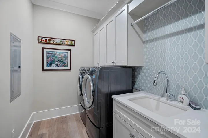 Laundry room with pocket door.  Washer/Dryer conveys.