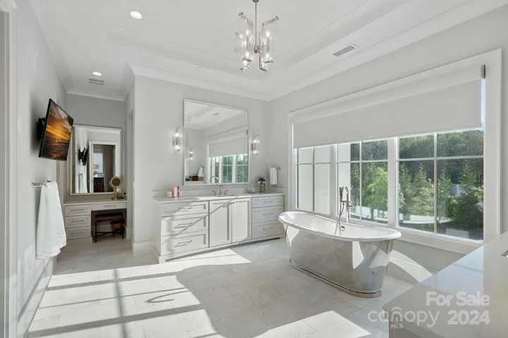 Primary bath has dual vanities and makeup area