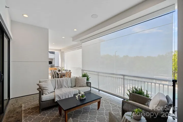 Electric sunshades provide both sunscreen and privacy along the poolside rails