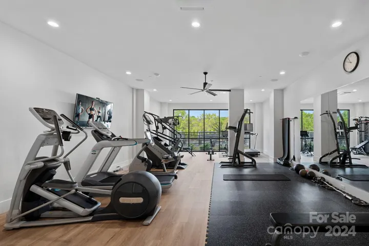 Fitness center features free weights, fitness equipment & Peloton bike & tread, plus adjacent shower facilities.