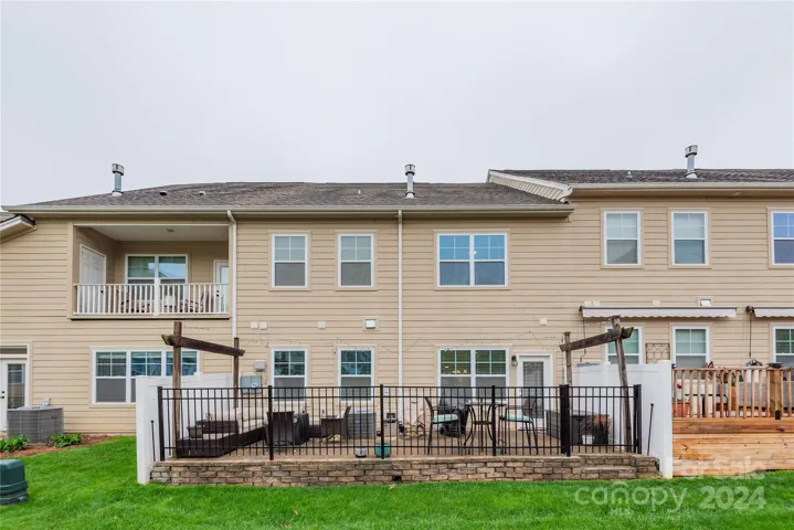 Large, gated patio with stone pavers and privacy on either side.