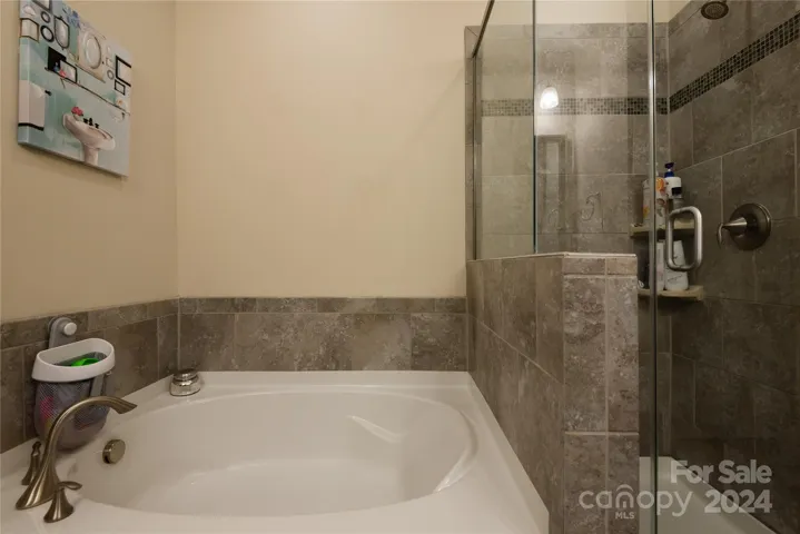 Primary garden tub and separate shower.