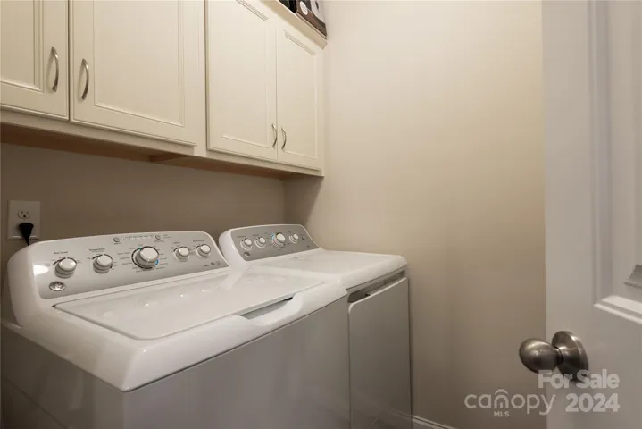 Laundry room off kitchen on main level.