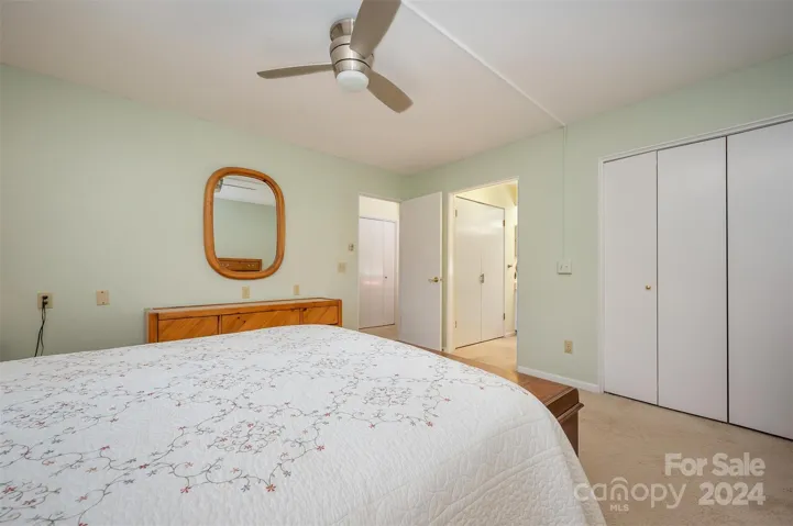 Another view of primary bedroom into the primary bathroom