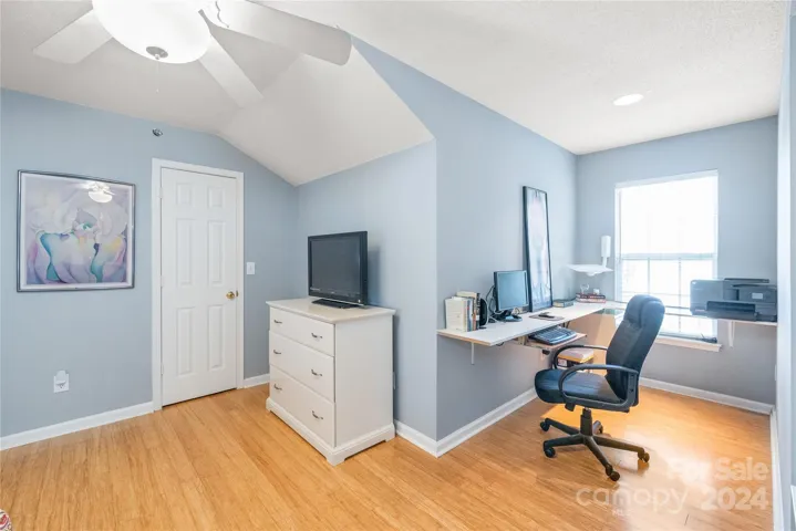 Bedroom 2 on the second floor with walk-in closet and LVP hardwoods.