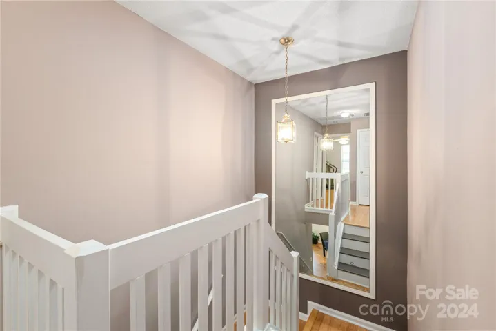 Custom made mirror located in the stairway creates an elevated experience.