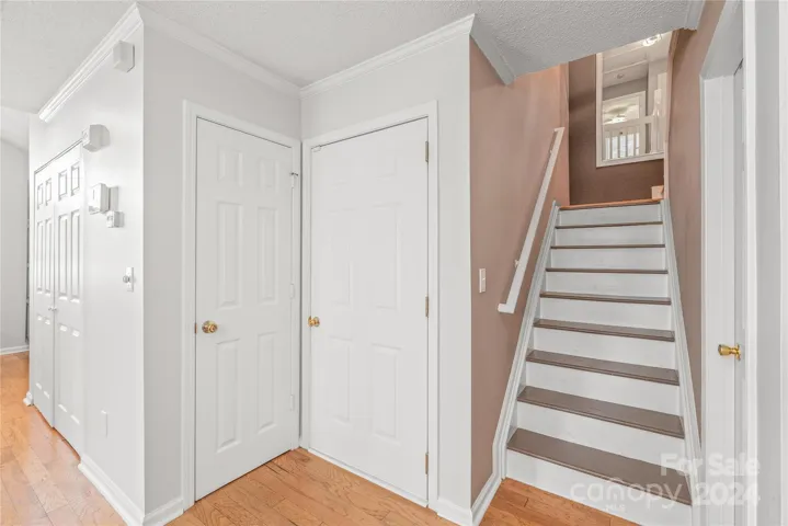 Access to the convenient attached garage and hardwood stairs leading upstairs to 2 additional bedrooms.