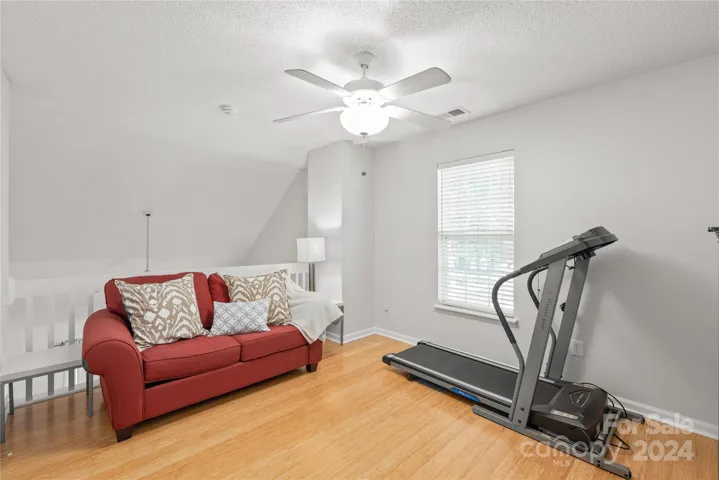 Bedroom 3 with walk-in closet, LVP hardwood floors, window for natural light and door for privacy. Half wall overlooks the great room for openness but can be easily closed off.