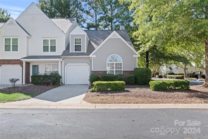 Meticulously maintained end-unit townhome, featuring a luxurious main-level primary suite.