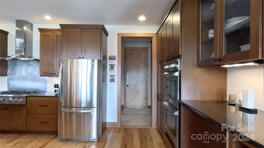 Kitchen with Double oven and great storage; heading towards garage and pantry.