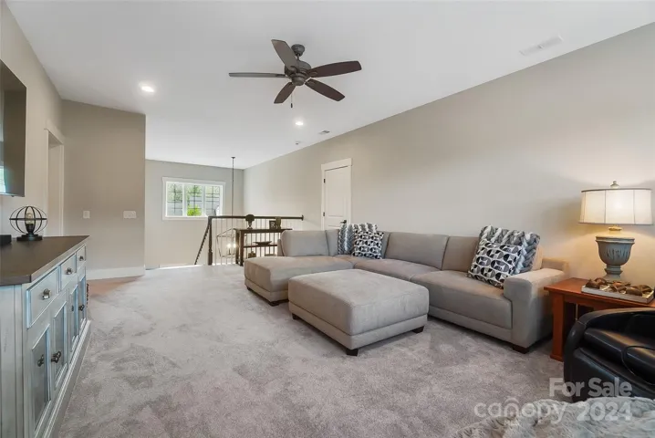 Upstairs, a versatile loft provides additional living space, perfect for use as a home office, play area, or cozy reading nook.